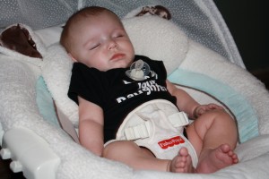 Newborn Baby Asleep in His Swing