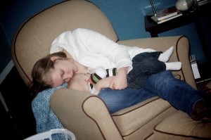Baby and Mommy Sleep in Chair While Nursing