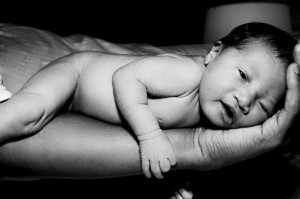 Image of newborn baby lying on hand