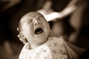 Newborn baby who is very unhappy.